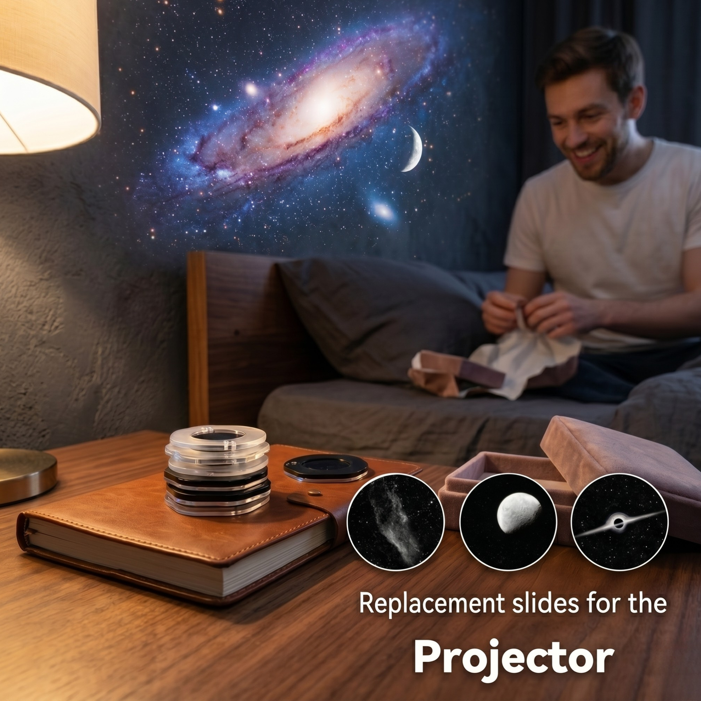 Man sitting on a couch with a galaxy projection, books, and projector slides on a table.